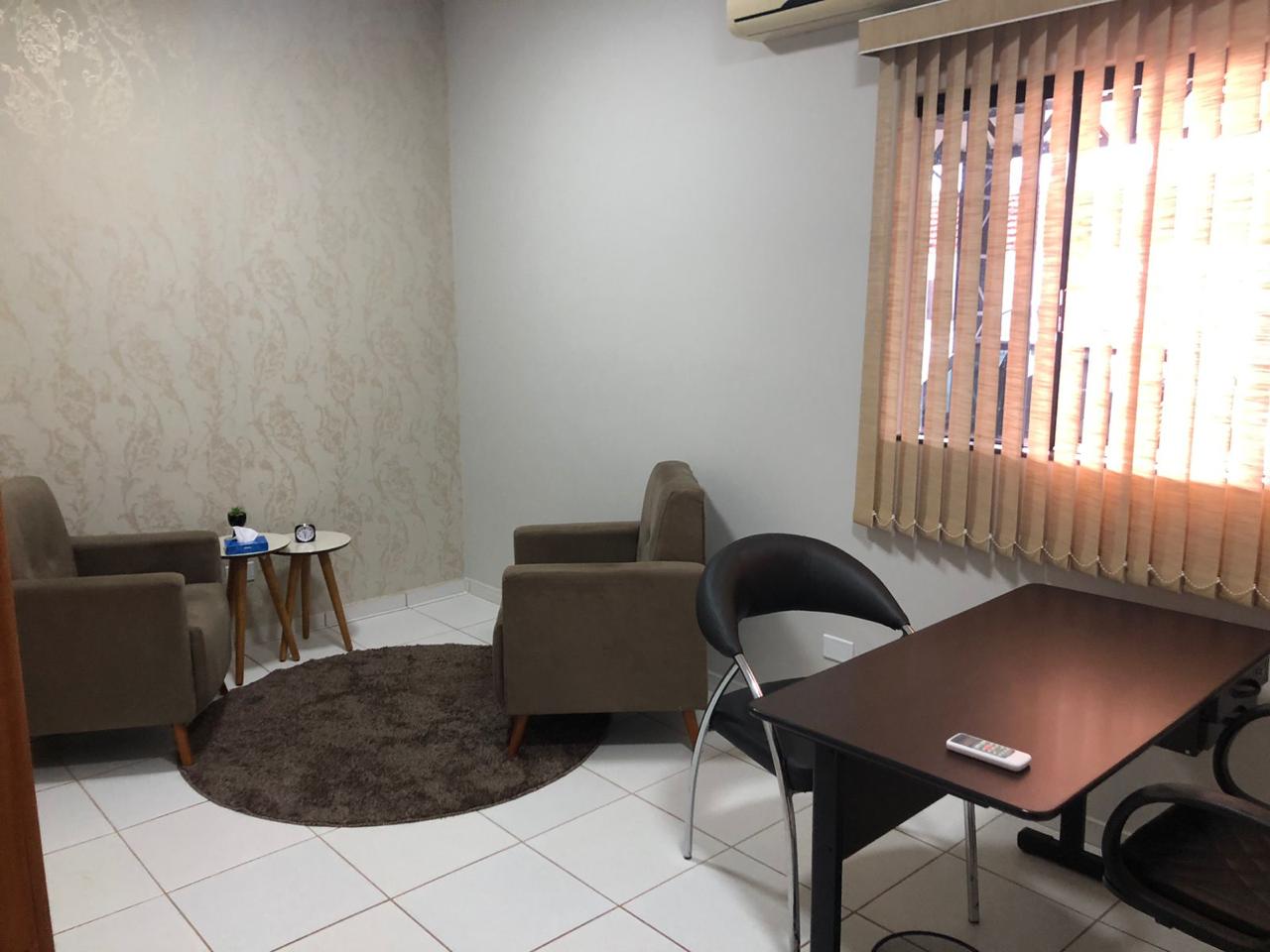 Sala privativa de atendimento com poltronas, mesa de apoio e tapete